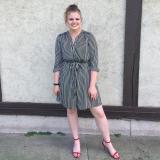 Image of Louisa standing against a white wall